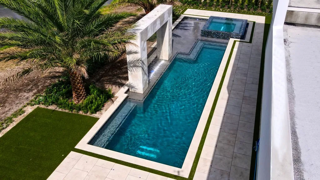 Aerial of finished pool shell, spa and deck, custom pool and spa in Boca Raton, FL