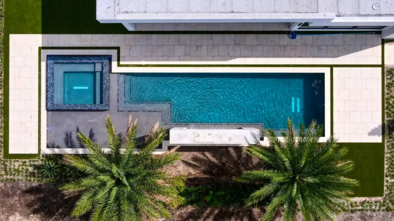 Aerial of a lakefront pool, glass-tile spa and porcelain water feature in Boca Raton