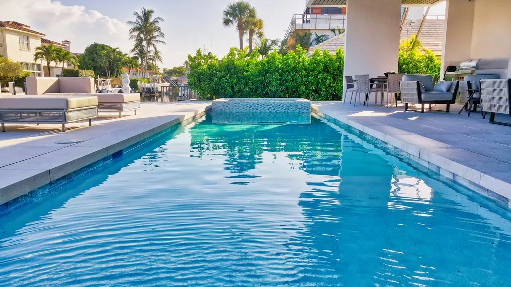 Long lap-style pool at water level, custom pool builder in Boca Raton, FL