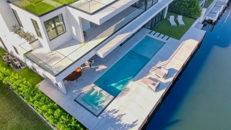 Aerial of a waterfront pool and raised glass-tile spa in Boca Raton