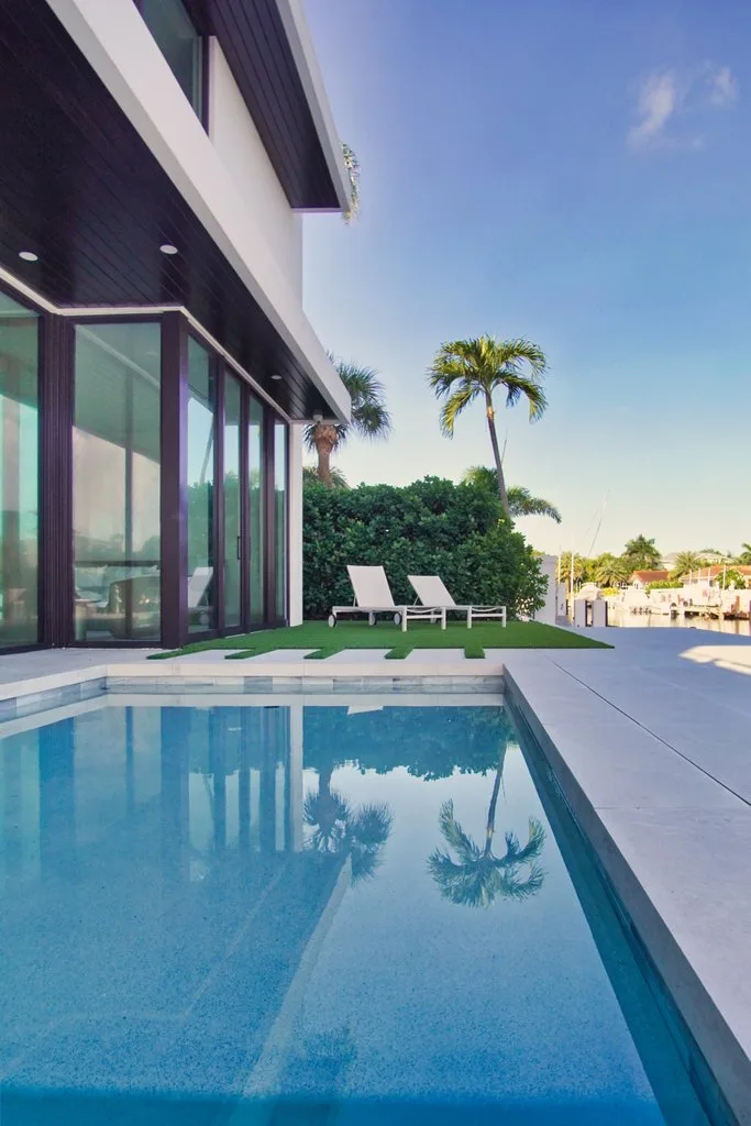 Pool and lawn with waterfront views, custom pool builder in Boca Raton, FL