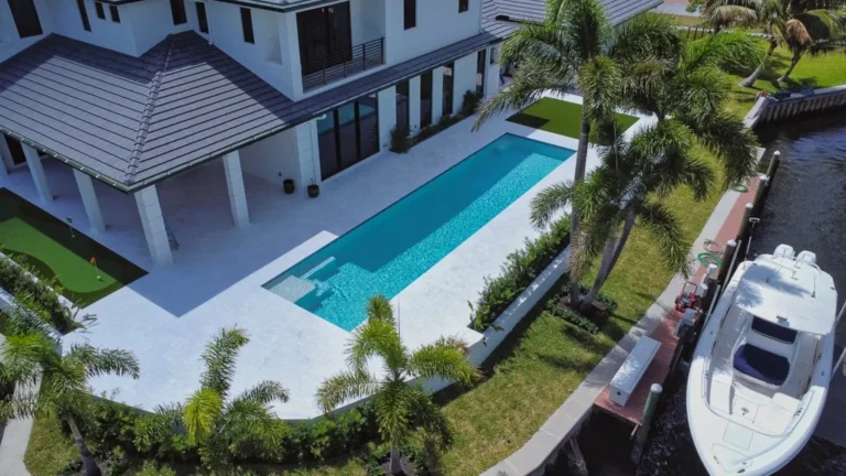 Aerial of a waterfront lap pool and dock in North Palm Beach