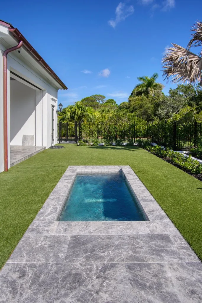 Plunge pool with turf and privacy landscaping, custom pool builder in Jupiter, FL