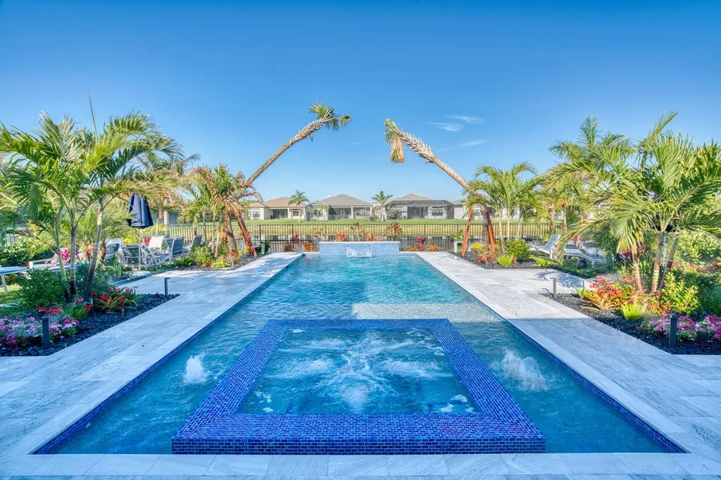 Custom pool and spa with sun shelf and glass tile in Boynton Beach, FL