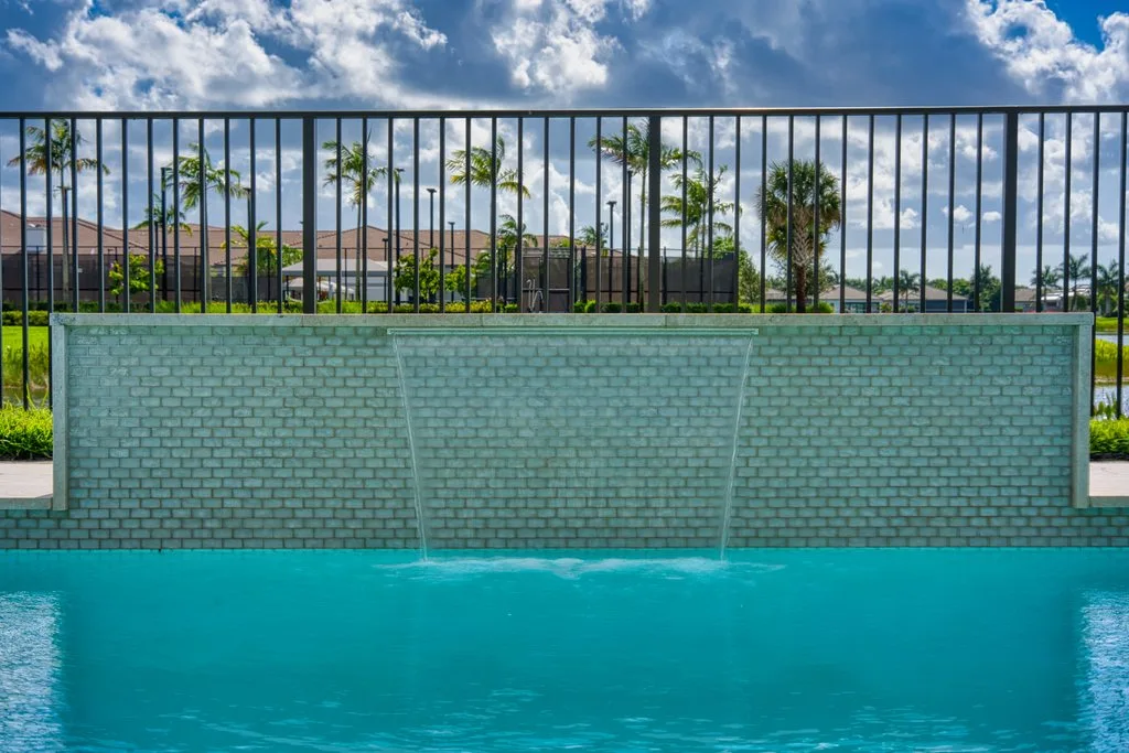 Custom pool with tiled sheer water wall and safety fence, Boynton Beach FL