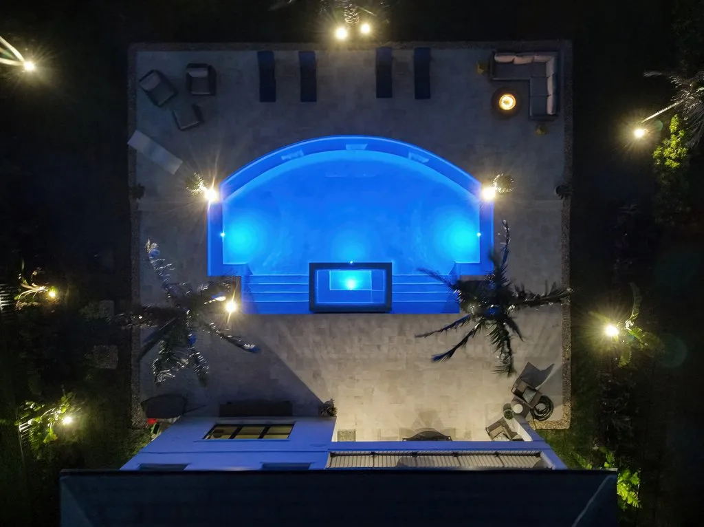 Night aerial of a lit custom pool and spa in Palm Beach Gardens, FL