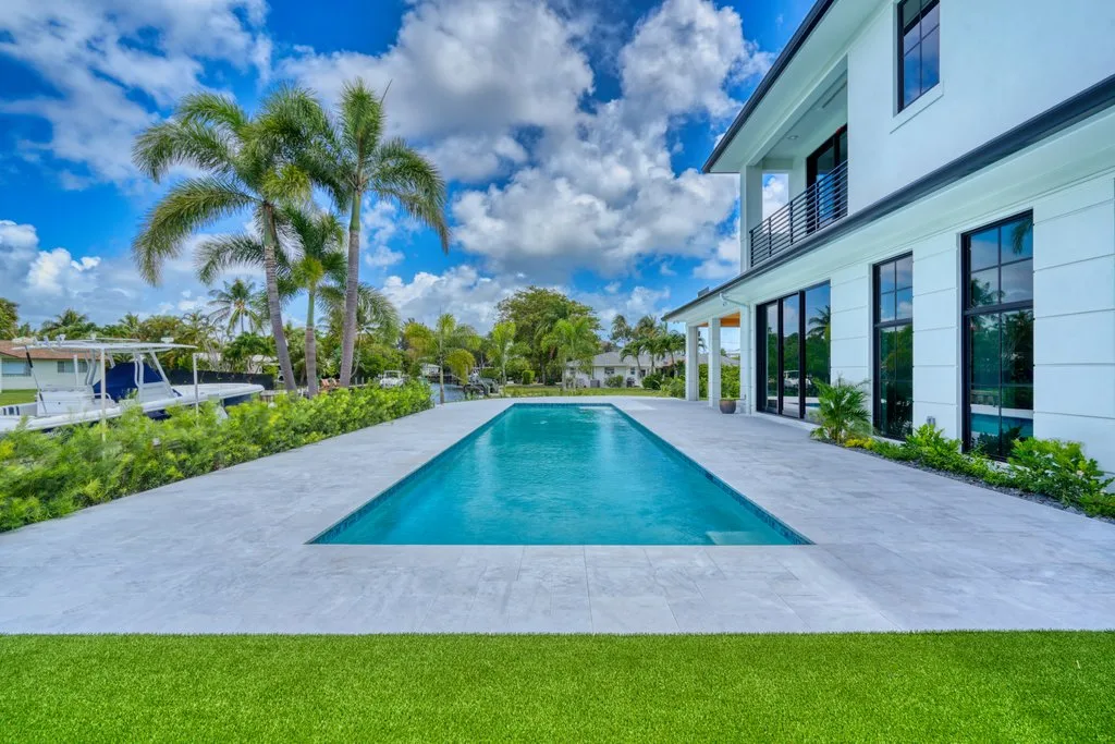 Pool, turf and canal views, custom pool builder in North Palm Beach, FL